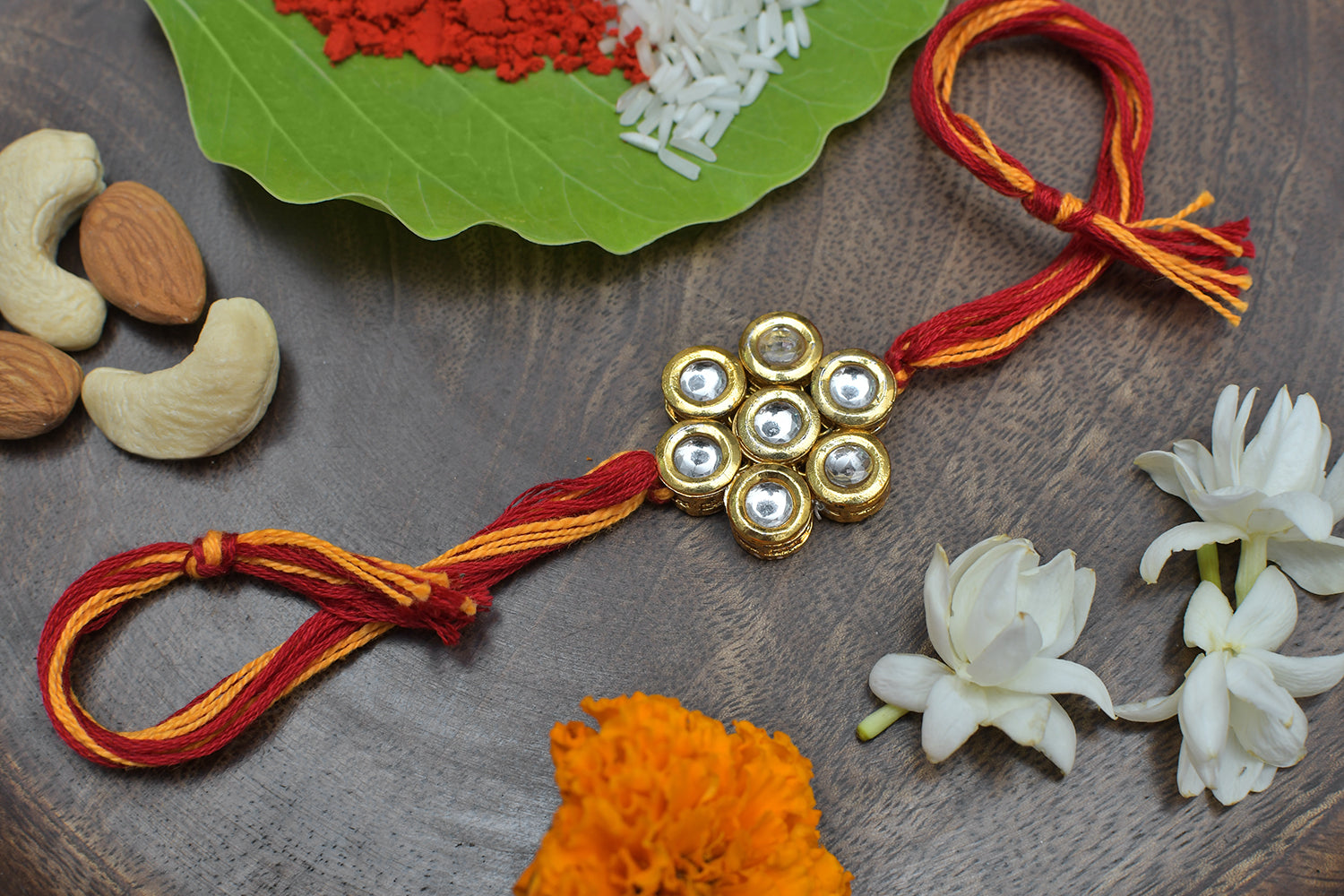 Kundan Floral Gold Tone Kundan Rakhi With Red Yellow Cotton Thread