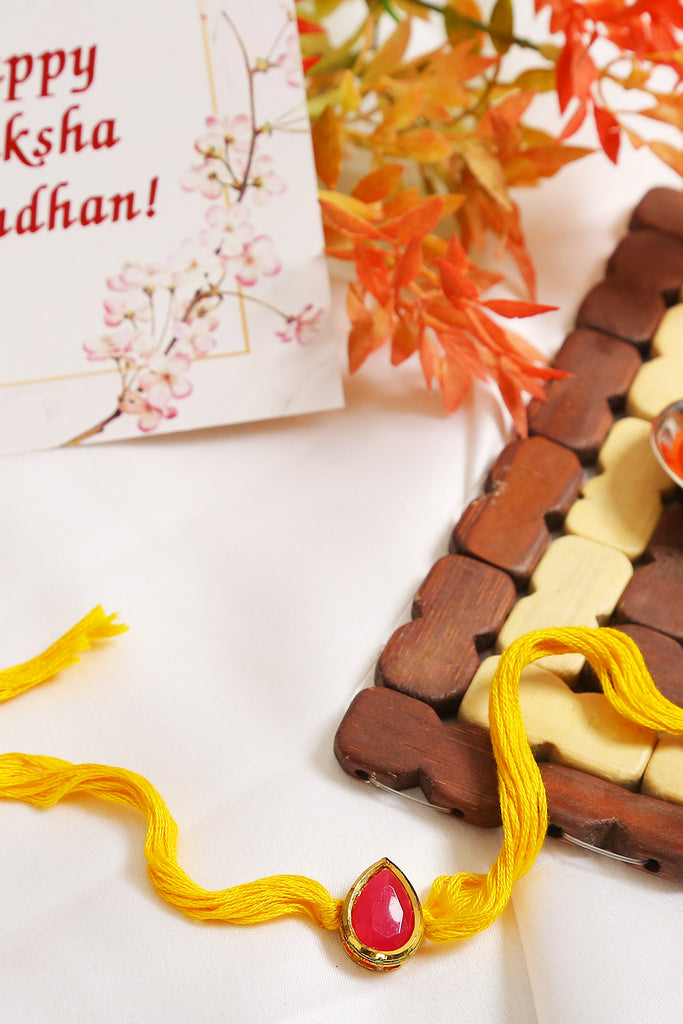 Red Gold Tone Kundan Rakhi With Yellow Thread