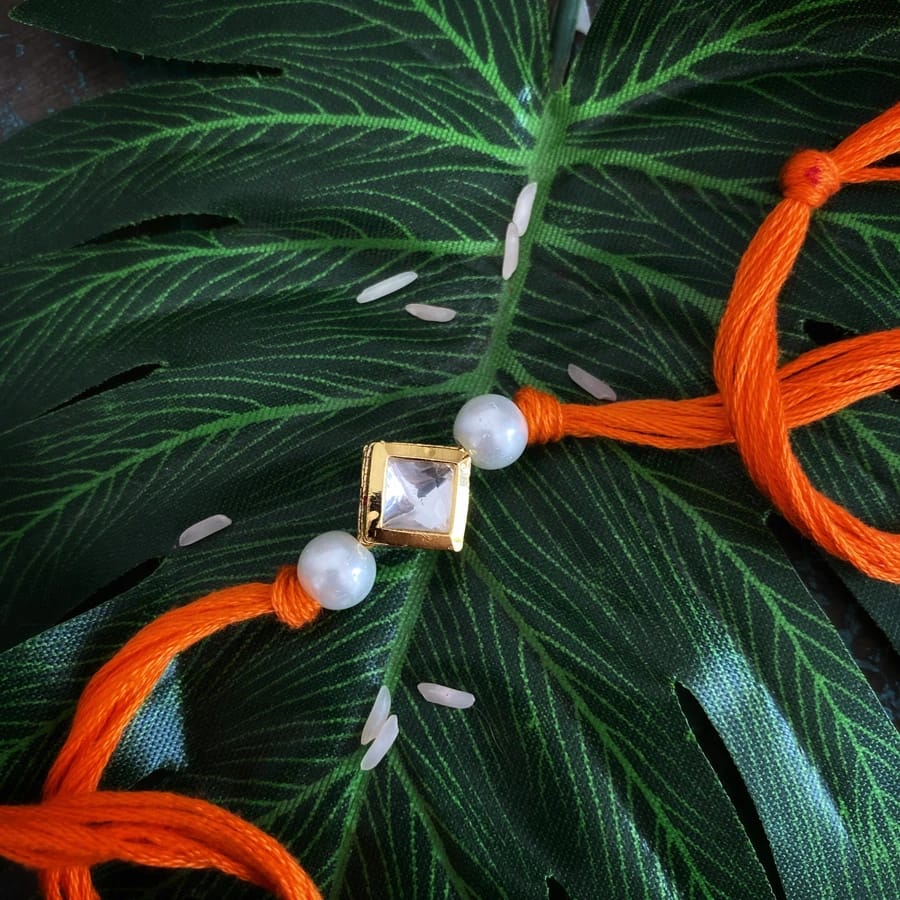 Orange Pearl Gold Tone Kundan Rakhi