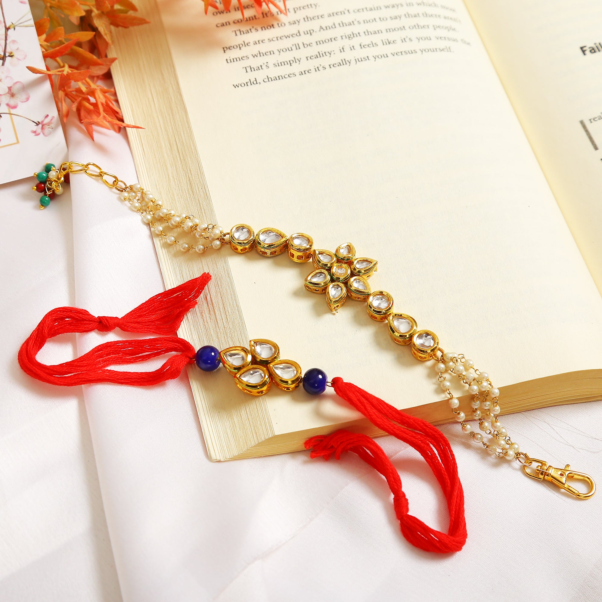 Set Of 2 - Gold-Toned Kundan Embellished Rakhi & Floral Lumba Set