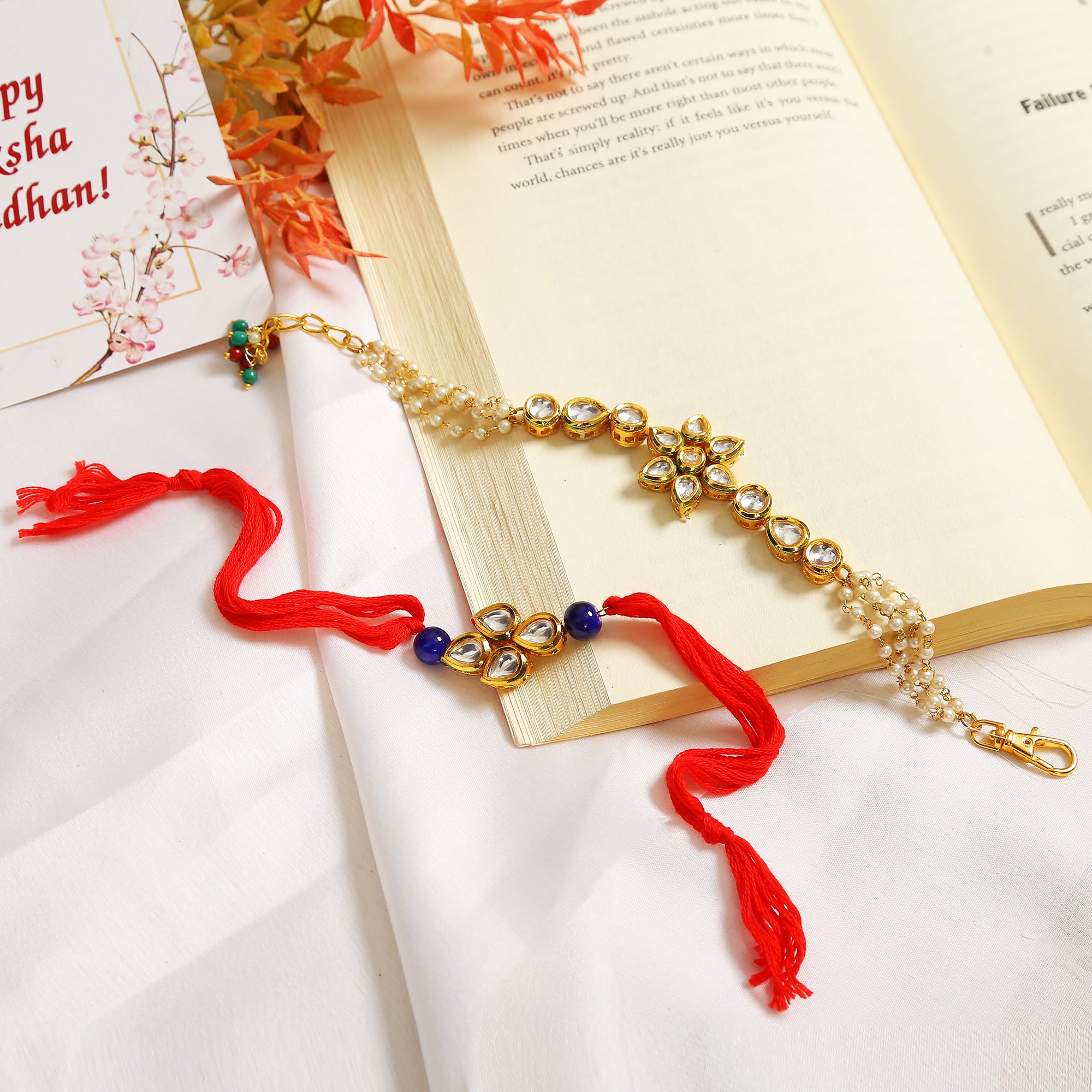 Set Of 2 - Gold-Toned Kundan Embellished Rakhi & Floral Lumba Set
