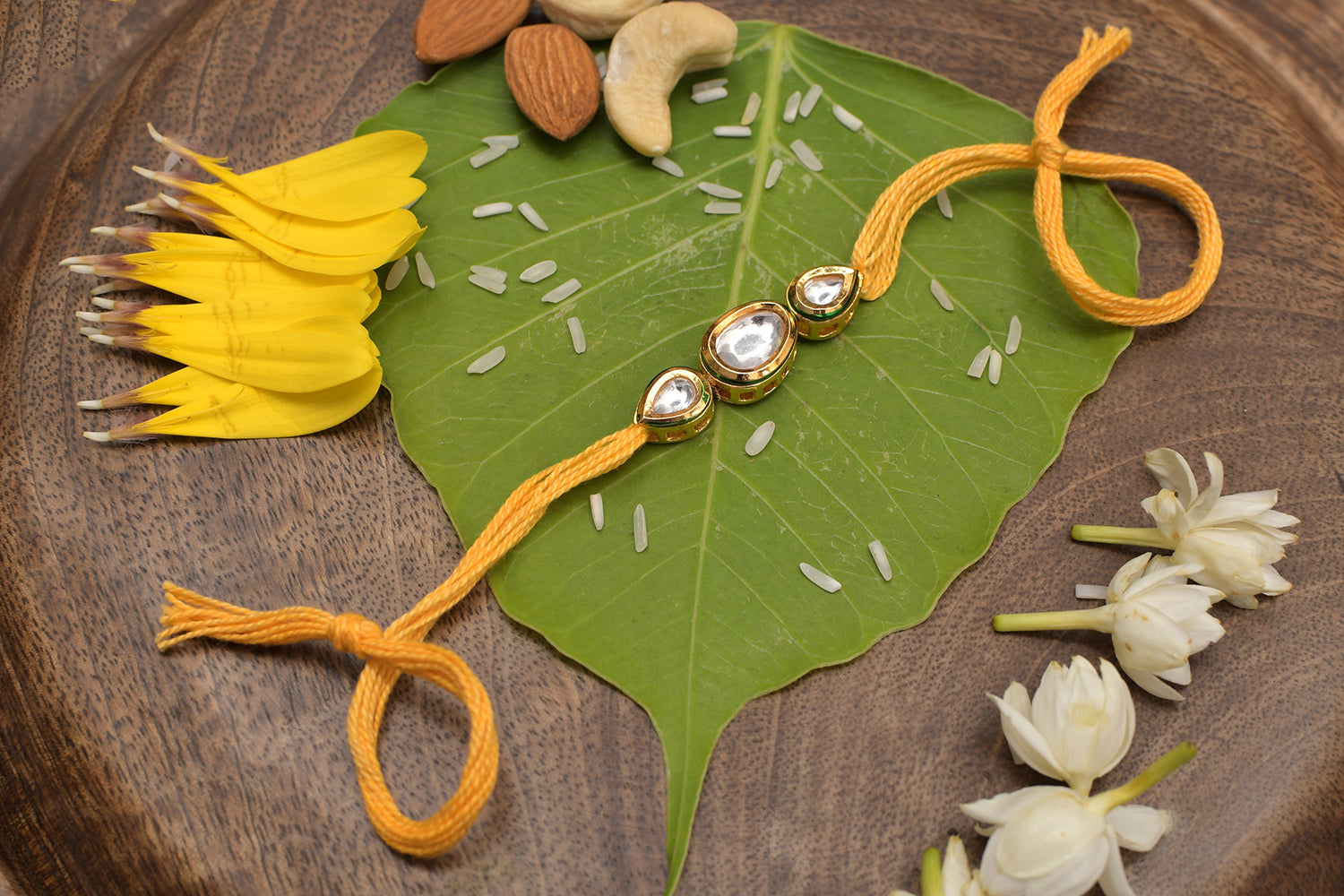Gold Tone Kundan Rakhi With Yellow Cotton Thread