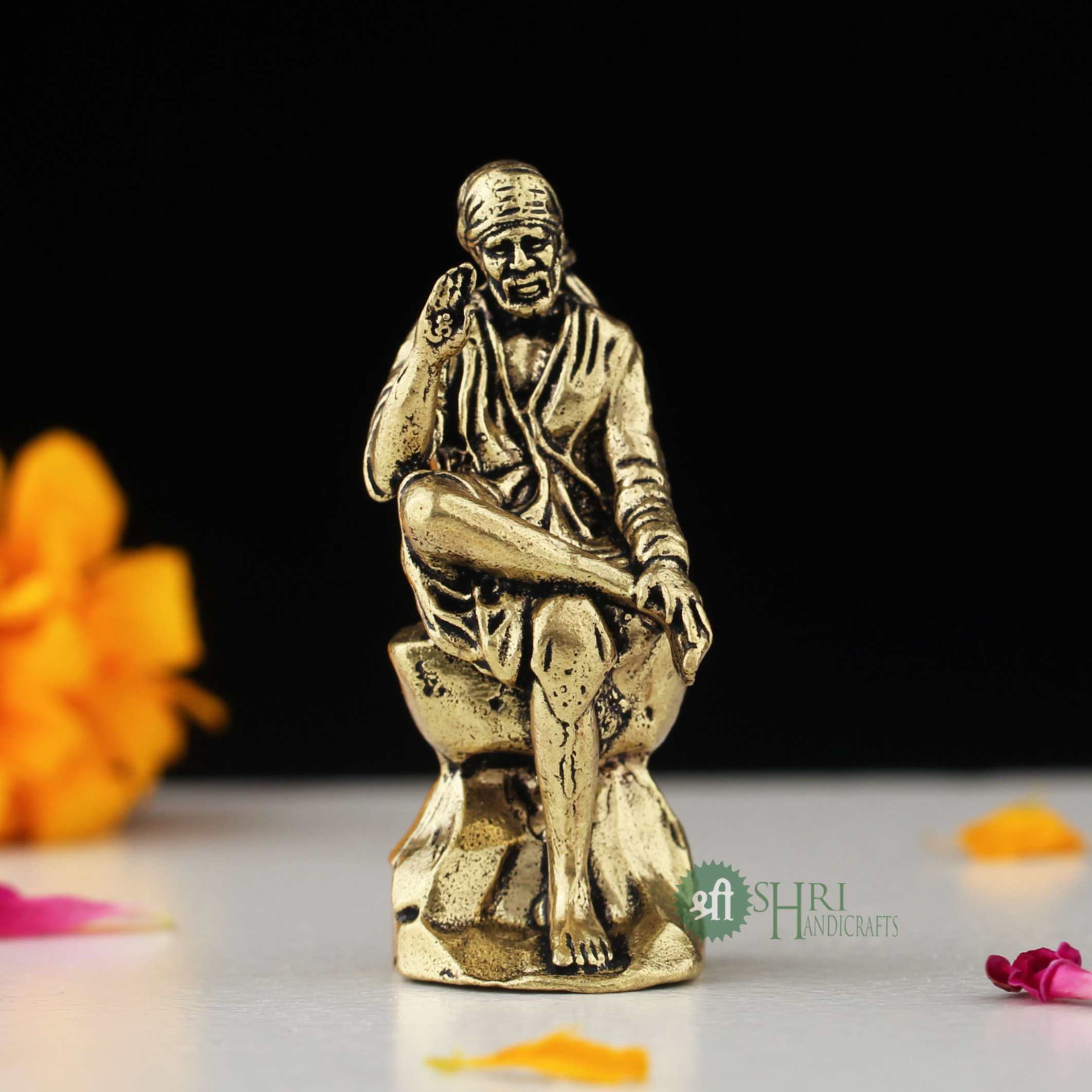 6" BRASS SAI BABA SITTING ON STONE