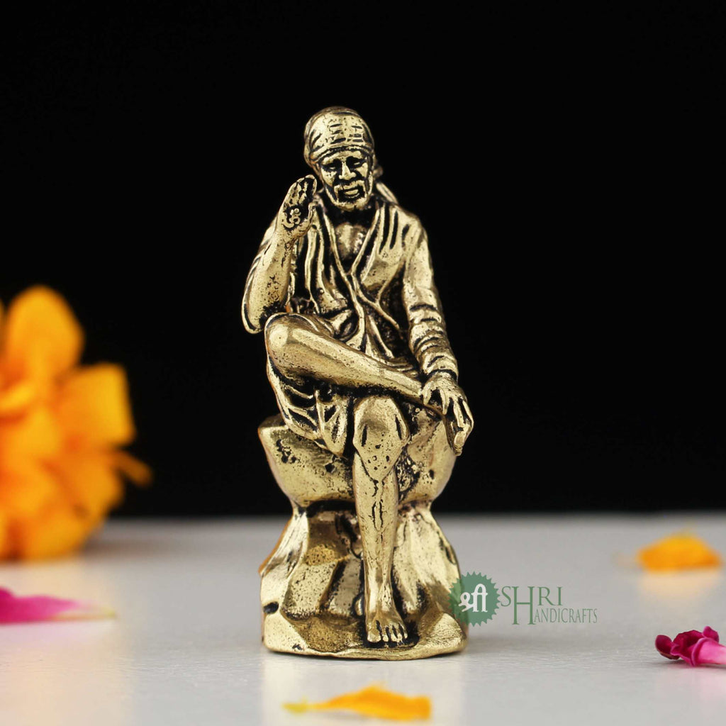 6" BRASS SAI BABA SITTING ON STONE