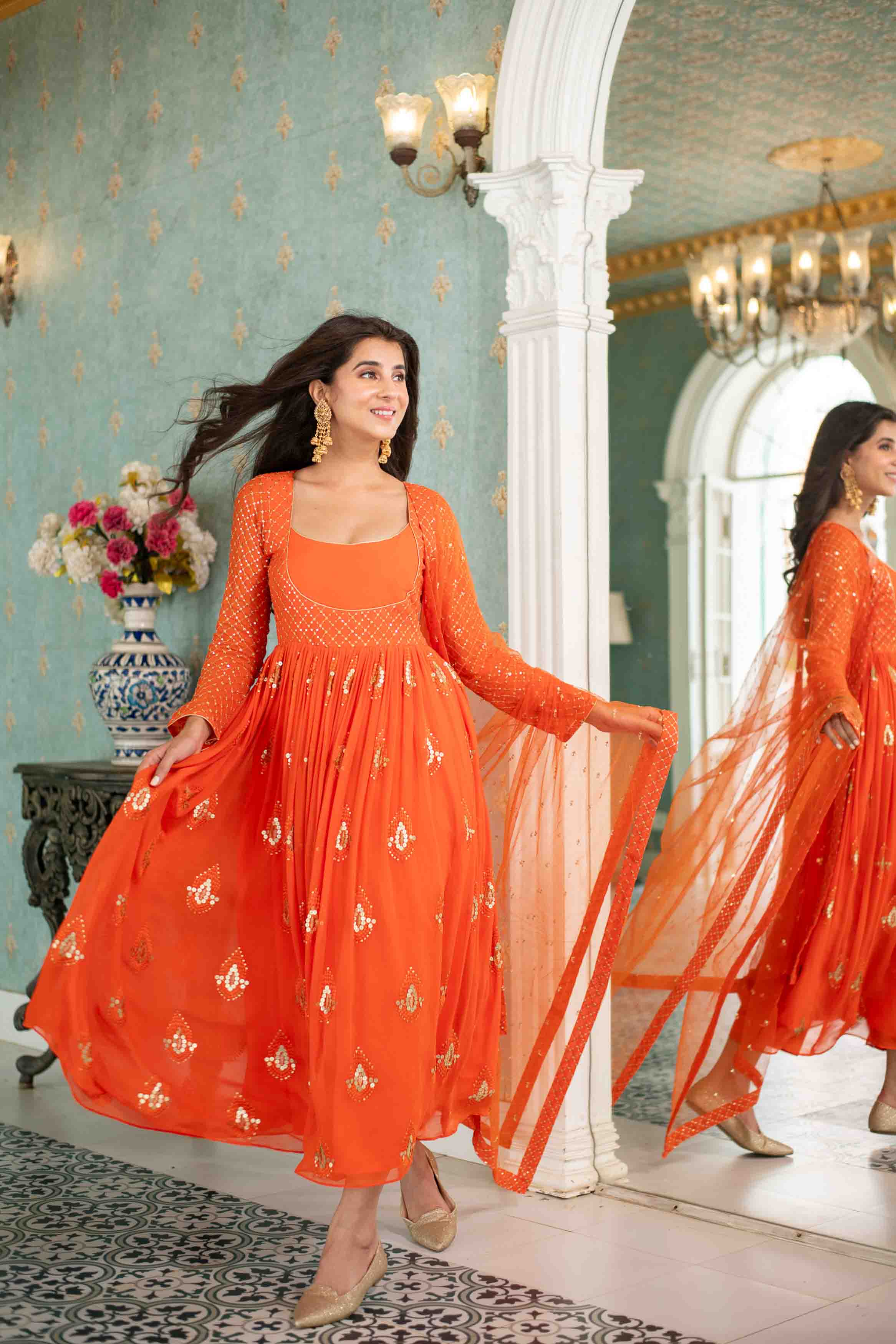 orange anarkali dress Dolly Orange Anarkali. , Step into elegance with this stunning orange anarkali suit that exudes timeless charm and contemporary grace. Crafted with delicate noodle straps that delicately frame the