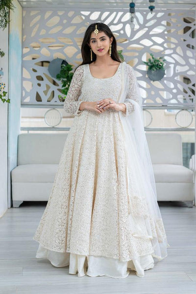 Off white anarkali with all over floral printed motifs. Comes with dupatta